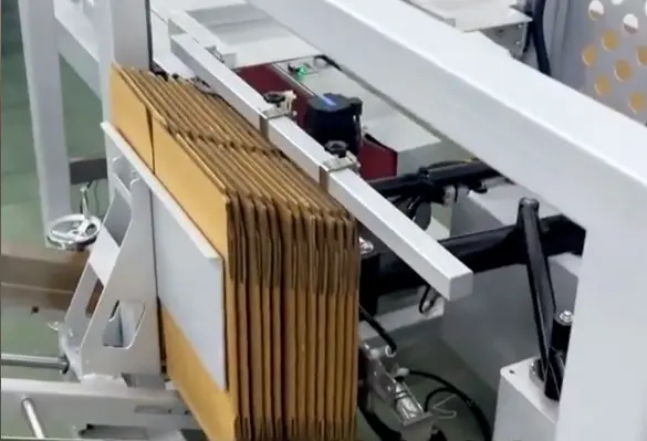 Flat-corrugated-cardboard-blanks-are-loaded-into-the-magazine-at-the-back-of-the-machine