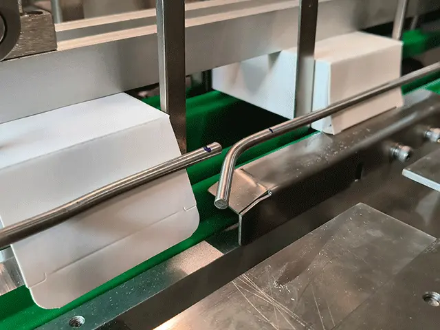 The-folded-flaps-are-held-closed-by-guide-rails-as-the-carton-continues-moving-forward
