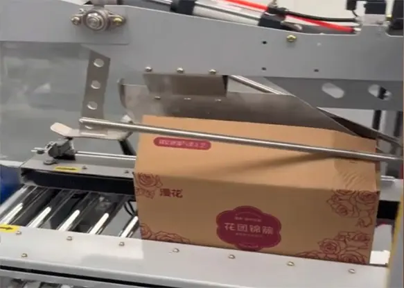 The-two-top-flaps-are-folded-inward-by-angled-metal-guides-1