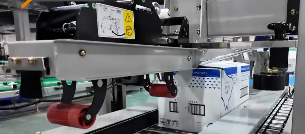 tape-is-pulled-from-the-tape-roll-and-pressed-onto-the-top-surface-of-the-box